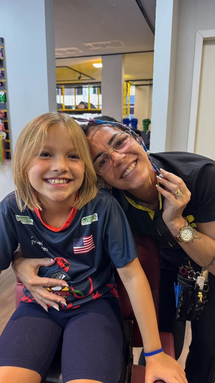 Menina sorrindo com a profissional da Abba Pai Kids